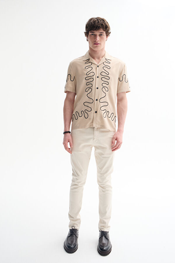 Off-white slim-fit jeans for men.