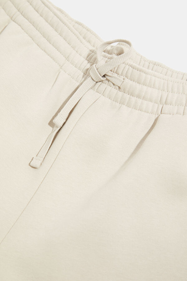 Cream-colored, straight-leg sports pants for men. 3