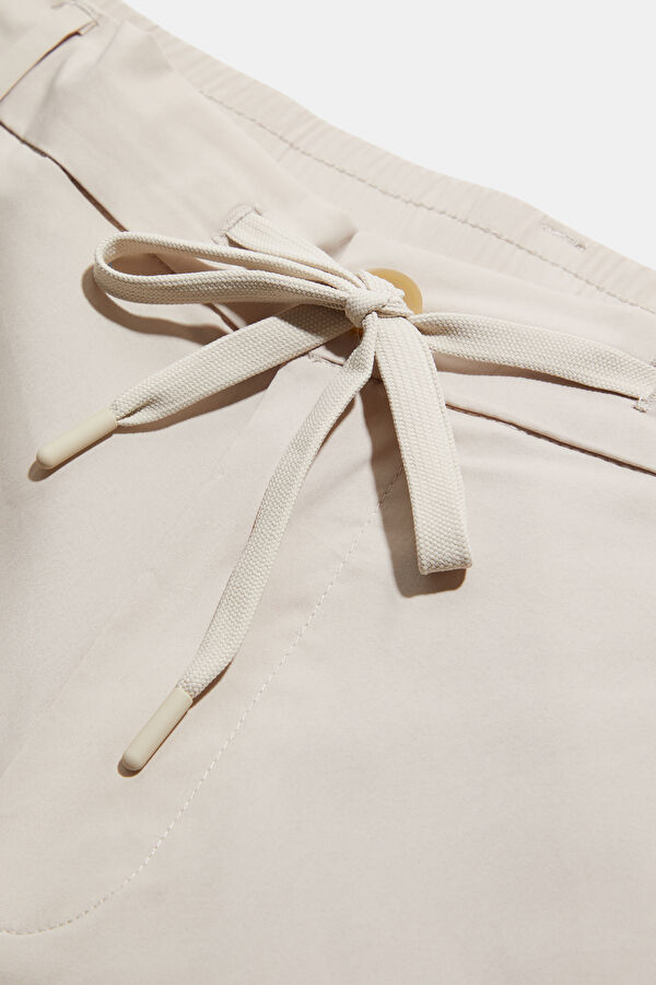 Cream-colored, straight-leg organic cotton men's trousers. 3