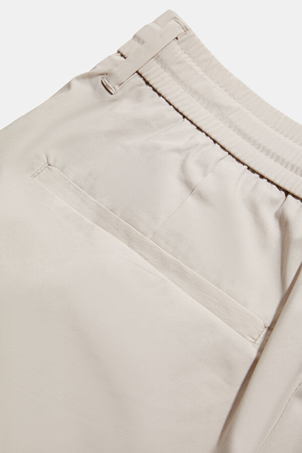 Cream-colored, straight-leg organic cotton men's trousers. 4